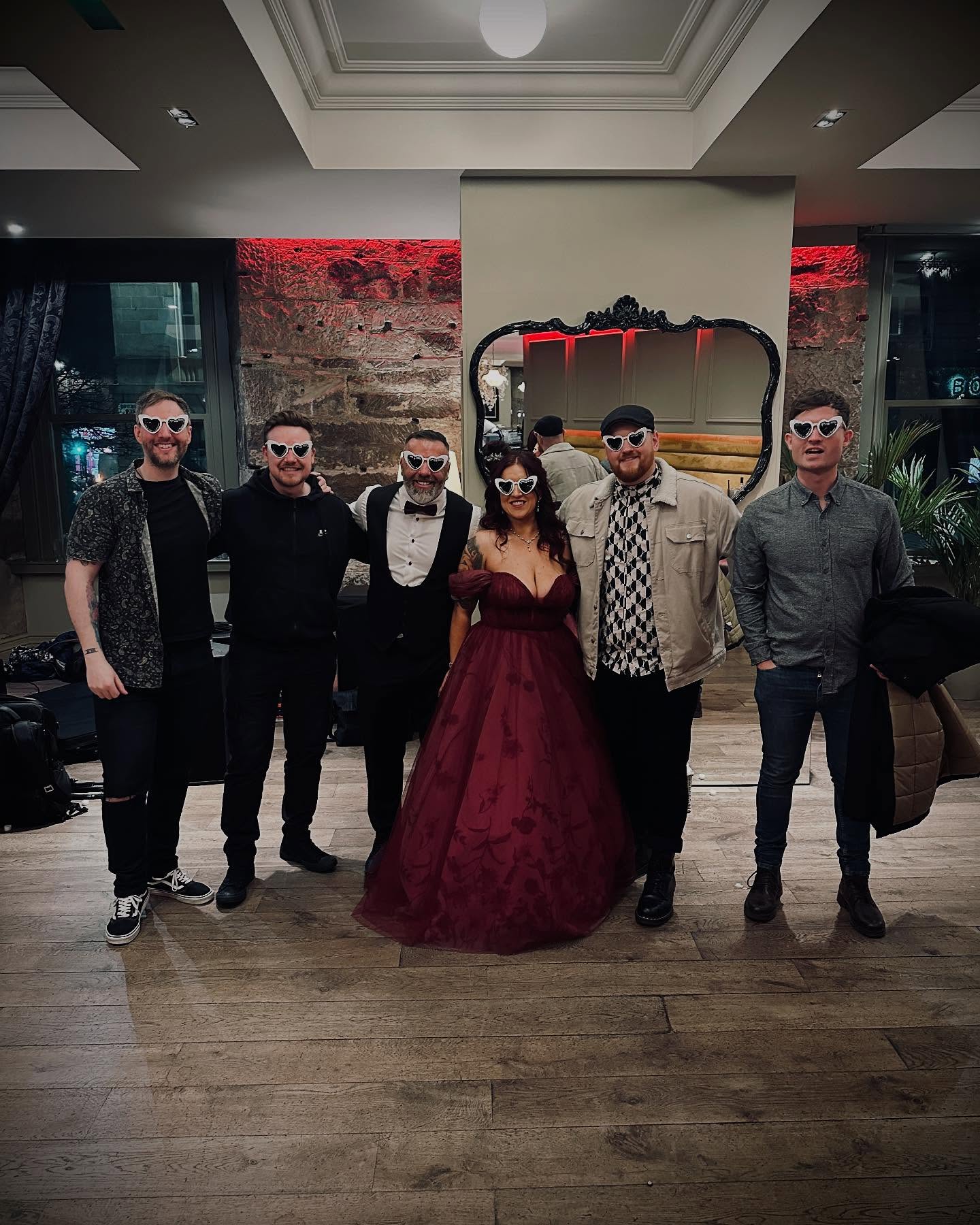Los Perros with a bride at a wedding